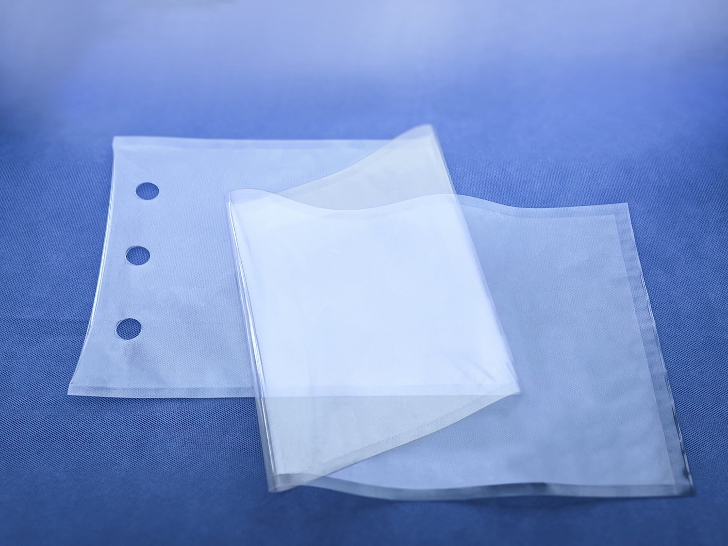 a clear plastic bag with three holes punched in the top