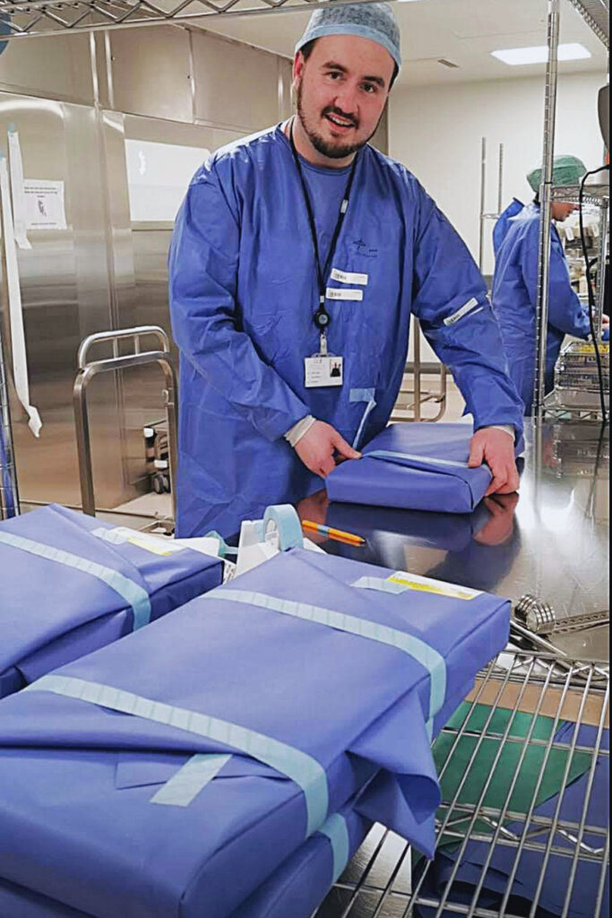 Jamie Dunne in blue scrubs in a hospital setting